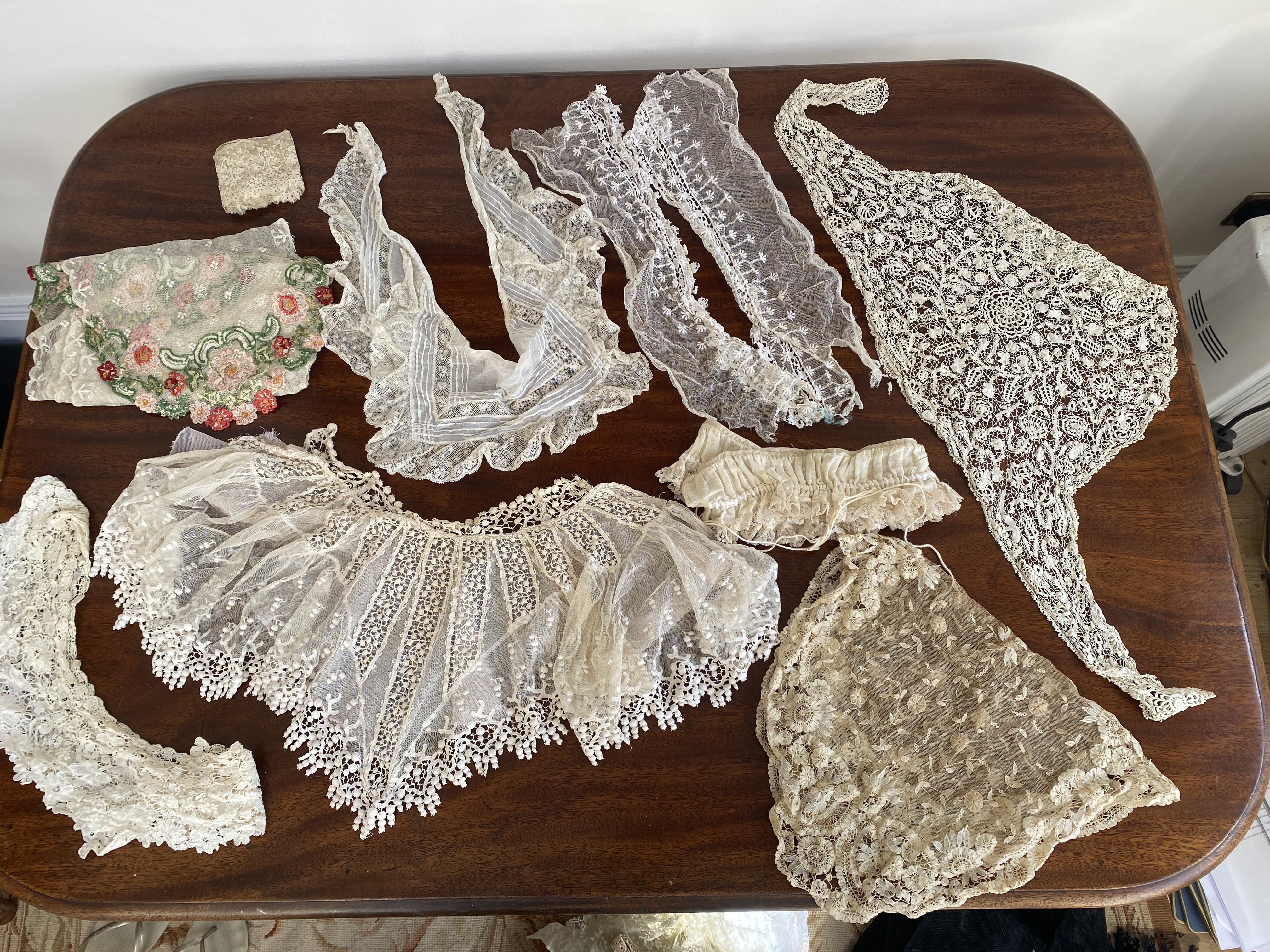 An assortment of black and cream lace pieces, antique, vintage and modern